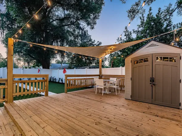 Back deck with string lights at a three-bedroom bungalow in Tampa, Florida